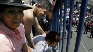 Patients' relatives outside rehab centre, Lima (28 January)