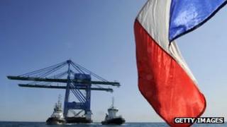 French flag in front of oil rig