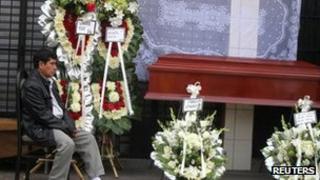 A man mourns his relative, a victim of a fire at a rehabilitation centre in Lima