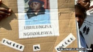 People hold up a poster of Zoliswa Nkonyana at a court hearing in September 2011 Copyright: Malungelo Booi/EWN