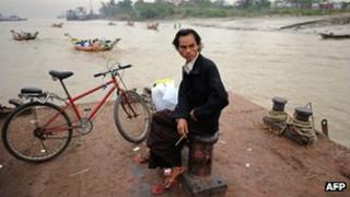 Burmese man waits to cross river near Rangoon