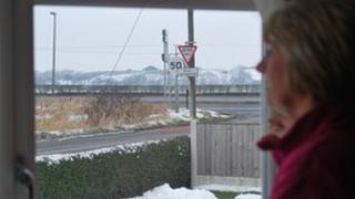 Resident looking out the window onto the tip