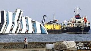 The oil tanker Elba and oil recovery sea platform Meloria are seen near the capsized cruise liner Costa Concordia on 12 February