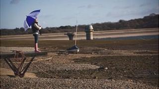 Person with umbrella at Bewl Water