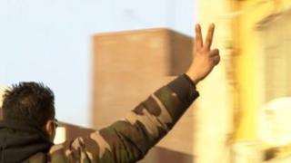Man celebrates the anniversary of the uprising that overthrew Col Muammar Gaddafi in Benghazi, Libya