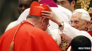 Pope Benedict XVI places a biretta on new Cardinal Timothy Dolan of the US at the consistory in Rome on 18 February 2012