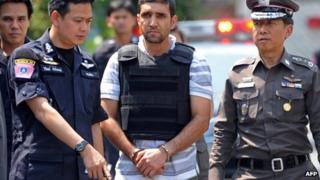 Thai police escort suspect Mohamad Khazaei to the scene of the first blast in Bangkok, 20 February
