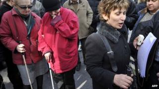 A blind woman chants slogans written in Braille during a demonstration in Athens against salaries and pensions cuts, 21 February