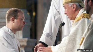 Andrew Hall (l) ordained as a priest by Archbishop Vincent Nichols