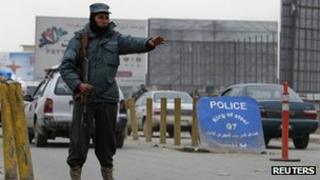 An Afghan policeman keeps watch at a check point in Kabul