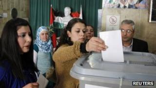Syrians vote during a referendum on a new constitution