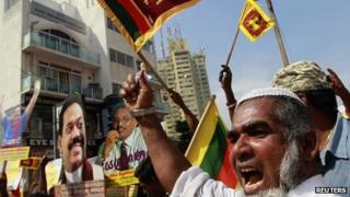 A supporter of Sri Lanka's President Mahinda Rajapaksa protests against the Geneva meeting