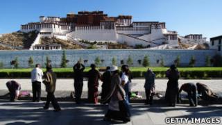 Tibetan pilgrims prostrate themselves in front of the Potala Palace in Lhasa (2009 file photo)