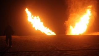 Two jets of flame apparently rise from the desert