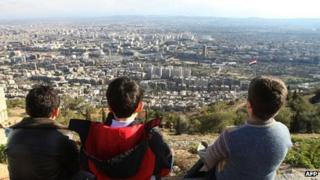 Boys look out at Damascus from a nearby hill (1 March 2012)