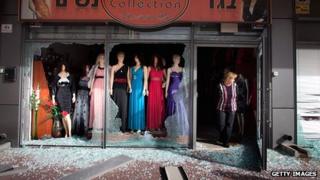 An Israeli woman surveys the damage to her shop following a rocket attack from the nearby Gaza Strip, on 12 March 2012 in Ashdod, Israel