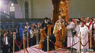 The body of Pope Shenouda seated in his papal chair during public viewing - 18 March