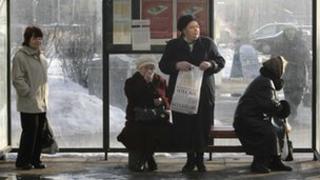 Women wait at a bus stop in Estonia