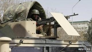 An Afghan National Army soldier keeps watch at the site of motorcycle bomb attack in Kandahar province March 14, 2012.