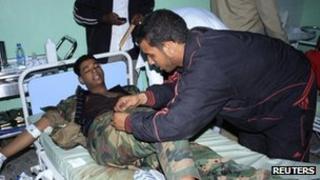 An injured fighter receives treatment at Sabha Hospital after clashes between rival militias