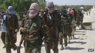 Al-Shabab recruits walk down a street on 5 March 2012 in Deynile to the west of Mogadishu