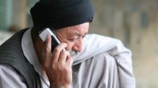 Middle aged Afghan man on his mobile phone in Kabul