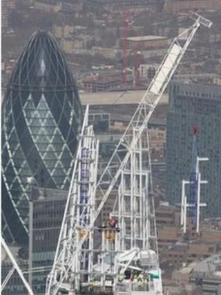 The highest part of the Shard is craned into place