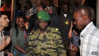 Malian junta leader captain Amadou Sanogo (C) leaves his office near Bamako on March 31