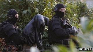 French special forces escort a suspect arrested in Coueron, near Nantes, 30 March