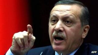 Turkey's Prime Minister Recep Tayyip Erdogan gestures during an address to members of parliament from the ruling AK Party (AKP) at the Turkish parliament in Ankara