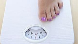 Woman weighing herself