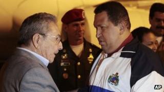 Cuban President Raul Castro (left) greets Hugo Chavez on his arrival in Havana on 31 March 2012