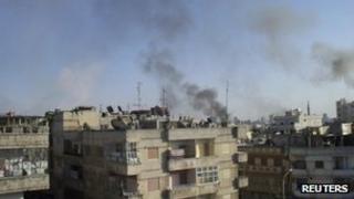 Smoke rises from the Al Qusoor district of Homs