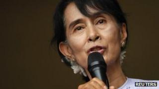 Aung San Suu Kyi addresses supporters and reporters from behind the gates of the National League for Democracy (NLD) office in Yangon 2 April, 2012