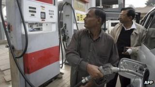 Consumers at a petrol pump in Bangladesh