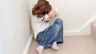 Young girl hiding her face
