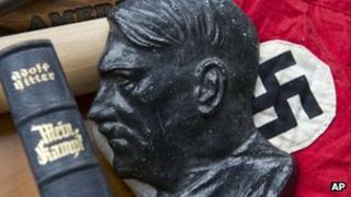 Copy of the book Mein Kampf, metal head of Adolf Hitler and Nazi swastika flag 13 March 2012