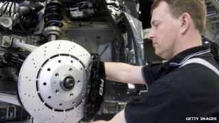 An employee of the Quattro AG, a subsidiary of Audi, works on the brakes of an Audi R8 on the assembly line in the plant at Neckarsulm, southern Germany