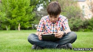 Boy using tablet in field