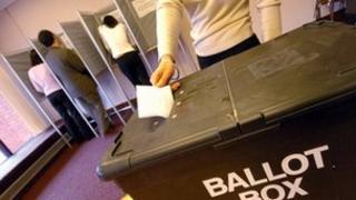 Vote being placed in a ballot box