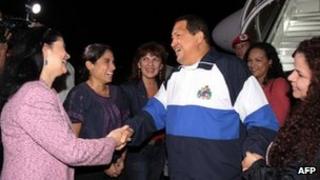 Venezuelan President Hugo Chavez (centre) on his arrival in Caracas on 26 April