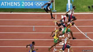 Justin Gatlin of the USA (second left) wins the 100m final ahead of Francis Obikwelu of Portugal in lane 5 at the Athens 2004 Olympics in Greece