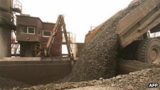 A truck unloads freshly excavated rock into a crusher at a copper mine in Indonesia