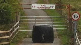 A hay bale blocks access to the lane