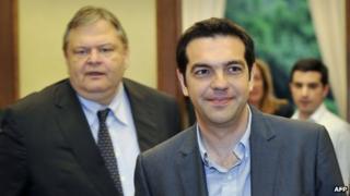 Alexis Tsipras (foreground), leader of Greece's biggest anti-bailout party Syriza, leaves talks with Pasok leader Evangelos Venizelos (left) in Athens, 11 May