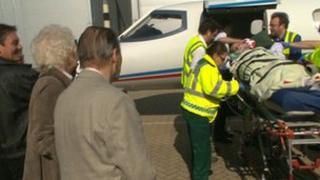 Terry Dukes' parents watch him being taken off plane