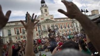 People gather during a protest to mark the anniversary of the "Indignados" movement at Puerta del Sol square in Madrid, Spain, on Sunday