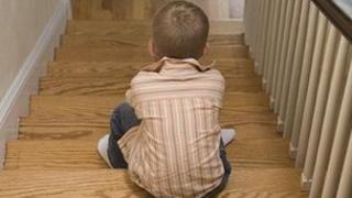 Boy sitting on stairs