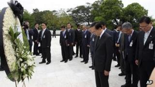 South Korean President Lee Myung-bak, center, pays a silent tribute to the victims of a bloody 1983 attack staged by North Korean commandos against visiting South Korean dignitaries, in Rangoon, Burma on 15 May, 2012