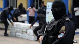 Members of the police drug squad guard at least 400 kg of cocaine seized in La Mosquitia on May 7, 2012.
